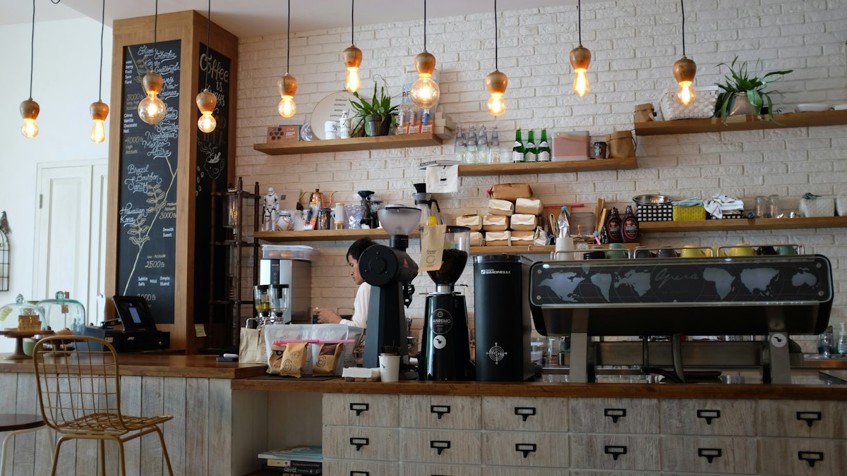 A warm café counter with pendant lights